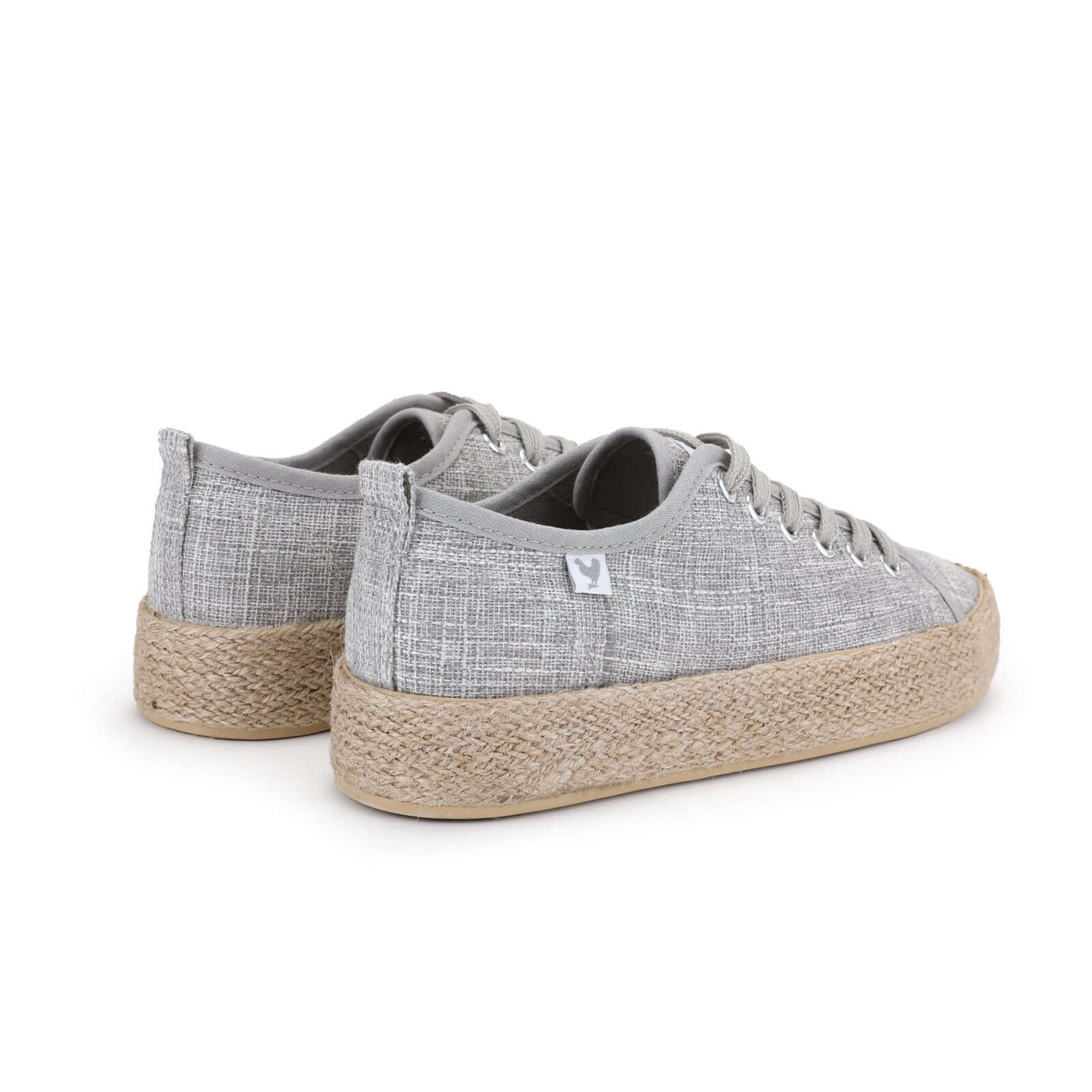 Gray linen lace-up espadrille sneakers with jute platform, offering Mediterranean style and comfortable rubber soles.