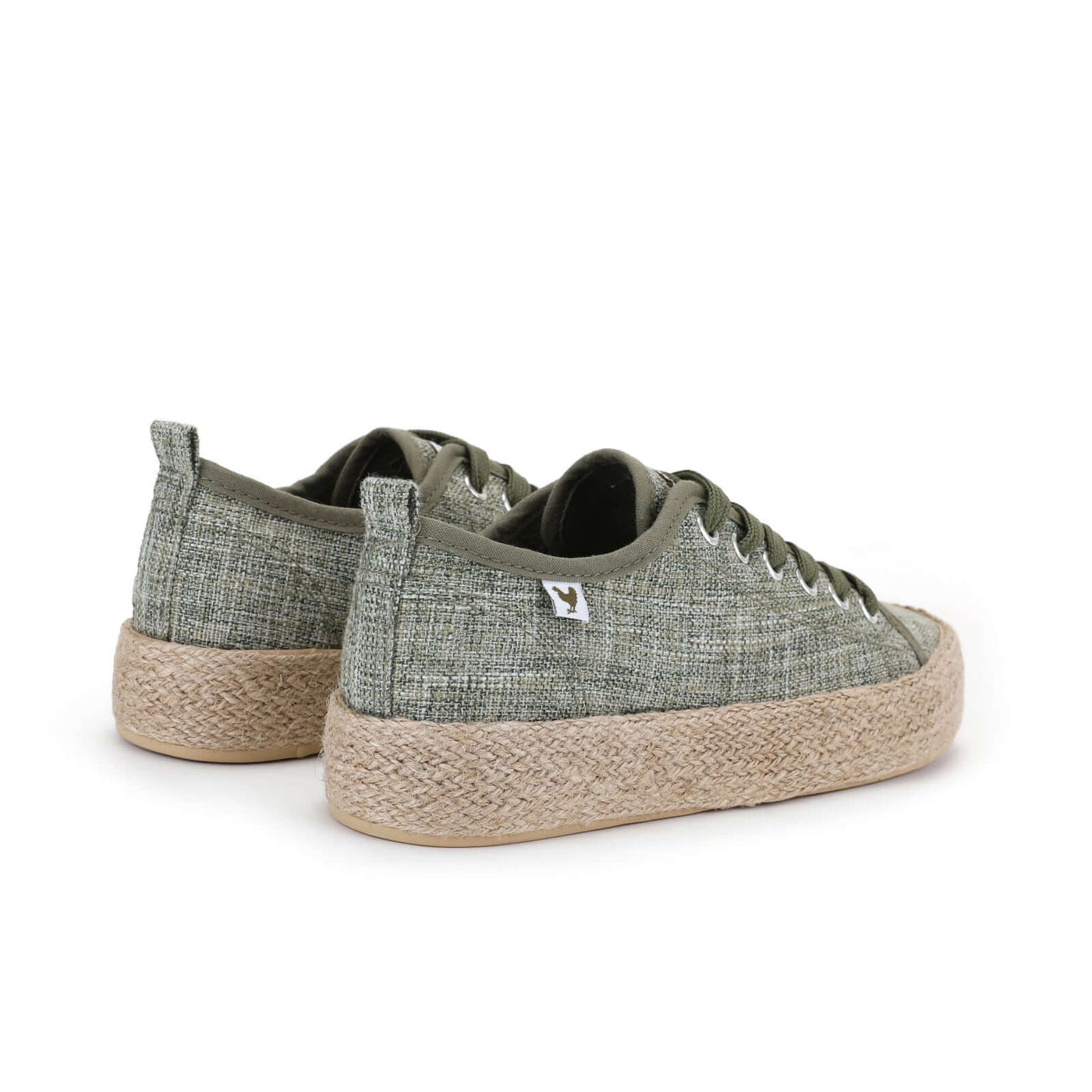 Green linen lace-up espadrille sneakers with jute platform and rubber sole, embodying a vibrant Mediterranean summer style.