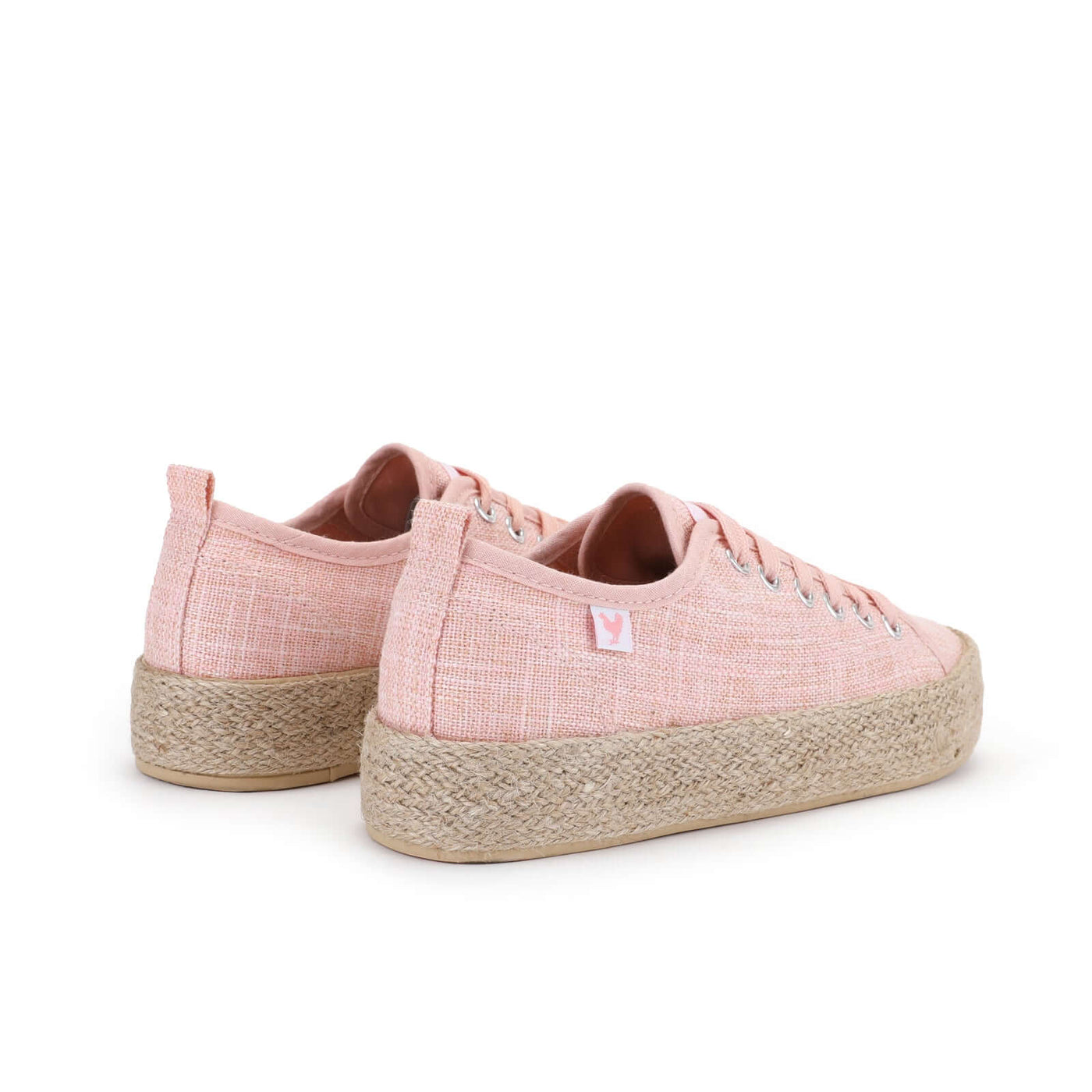 Pink linen lace-up espadrille sneakers with jute platform and rubber sole, showcasing vibrant Spanish summer style.