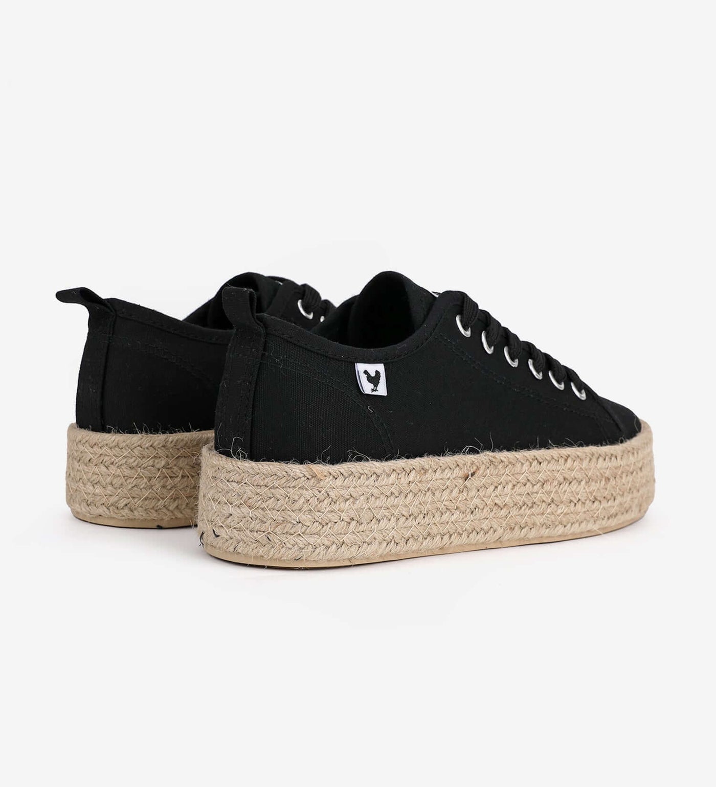 Black platform espadrille sneakers with jute band and lace-up design, showcasing Mediterranean style and comfort.