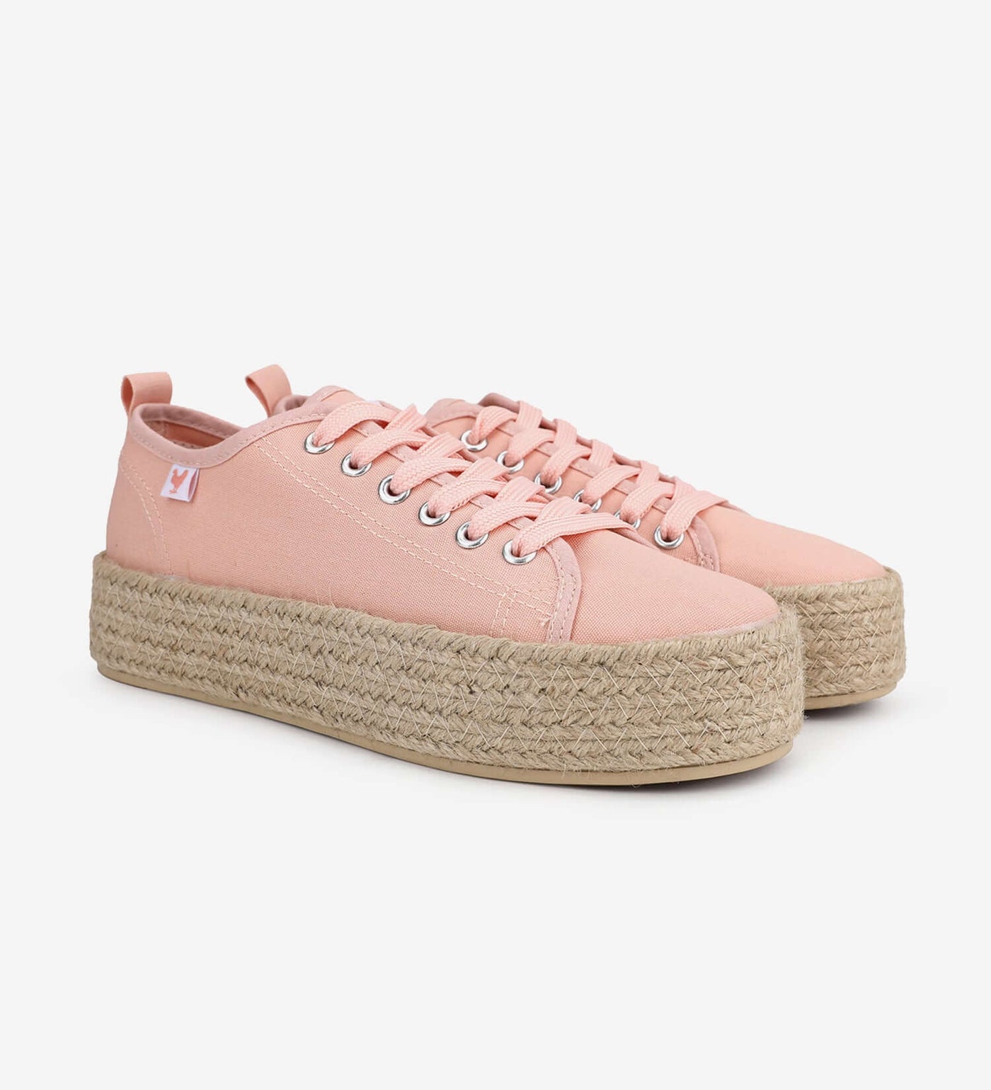 Pink canvas lace-up platform espadrille sneakers with jute soles for a vibrant Spanish summer style.