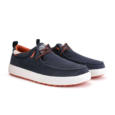 Biarritz Hi-Grip Wally shoes with navy cotton canvas upper, elastic laces, supportive heel, and orange rubber Pitas outsole.