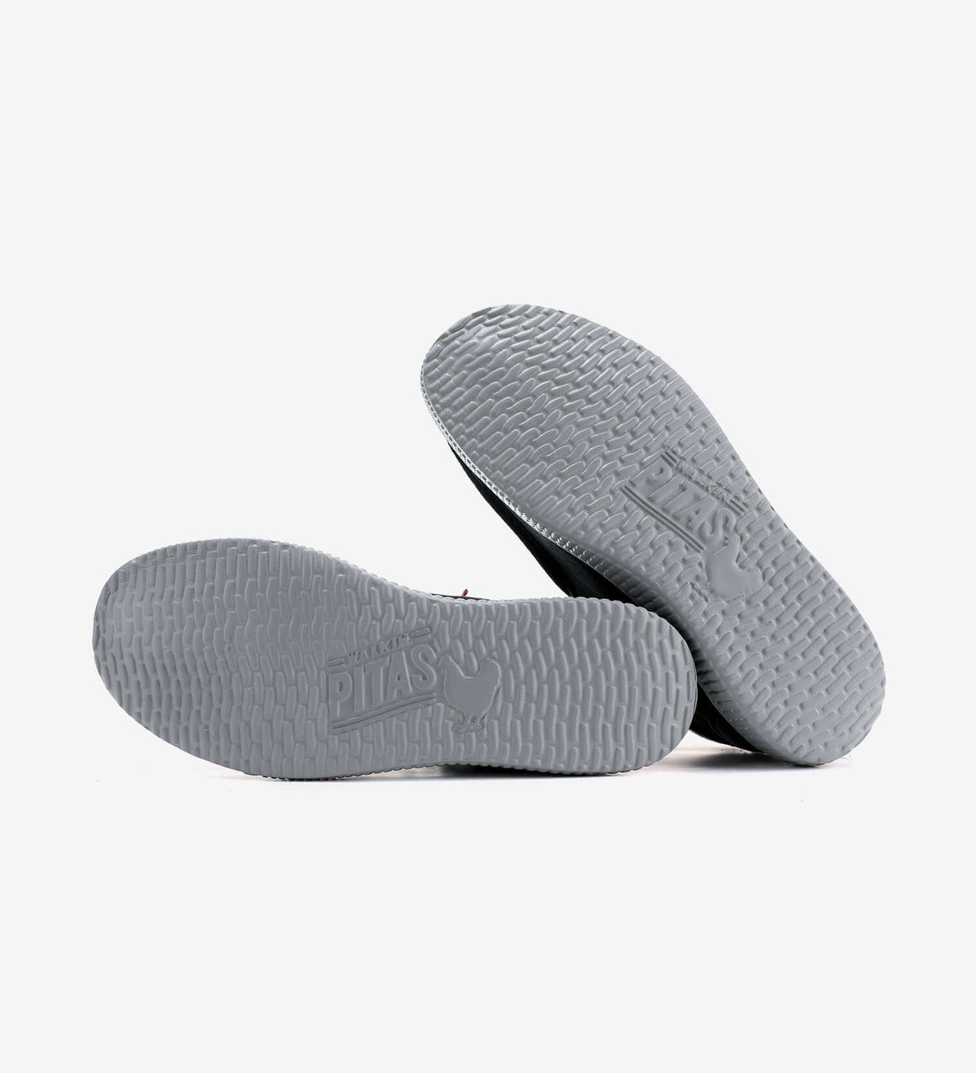 Grey outsoles of WP150 Bob Mocs by Pitas, featuring textured grip and brand logo, showcasing durable design for all-weather use.