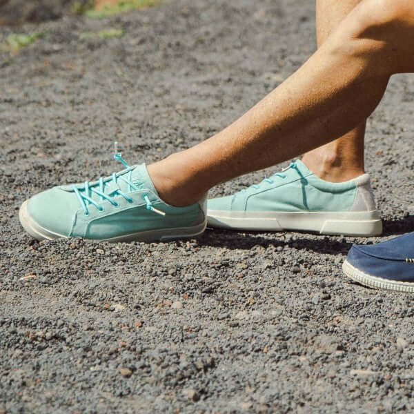 Person wearing Iris Ultralight Sneakers with elastic laces and cotton upper on a gravel path