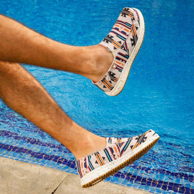 Man wearing Mundaka Ultralight Loafers with Aztec design near pool, showcasing slip-on style and cushioned sole.